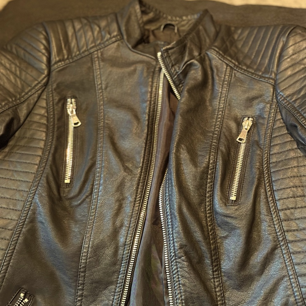 Medium fake leather jacket, fits more like a small only worn a couple times.